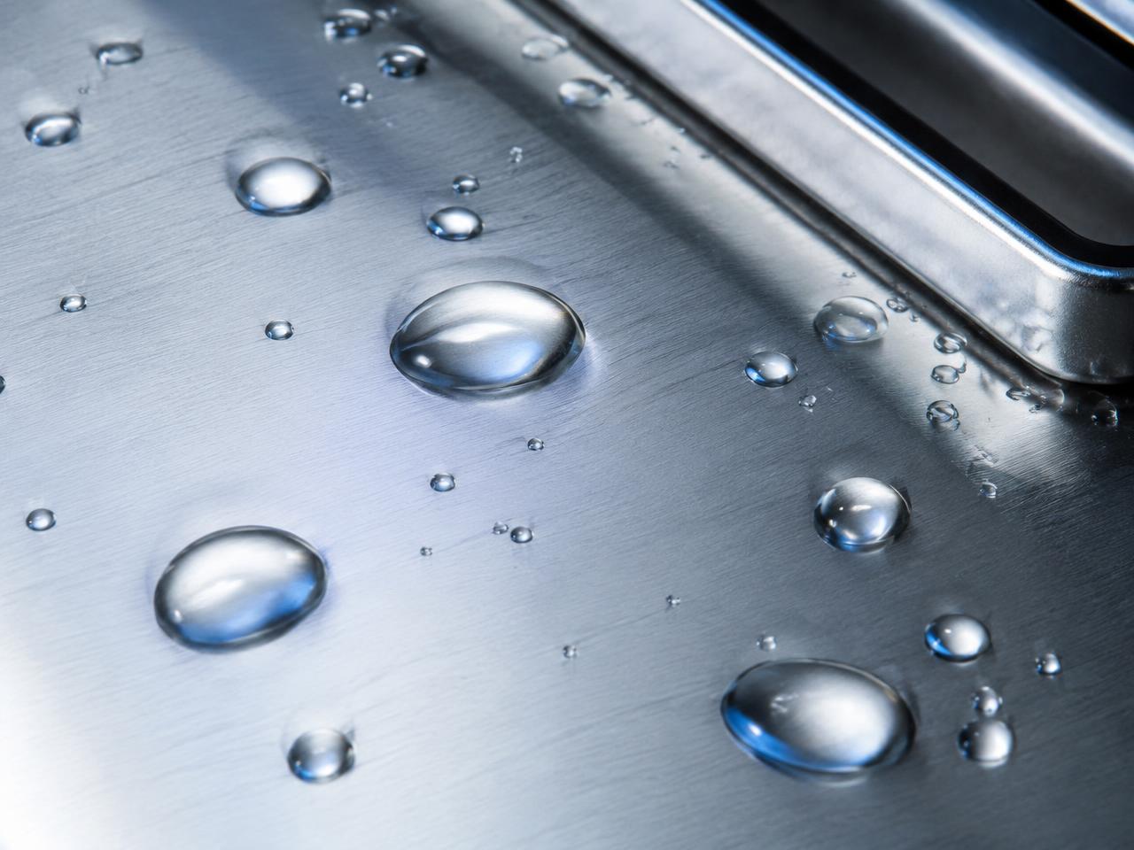 Finished stainless steel surface with water beading